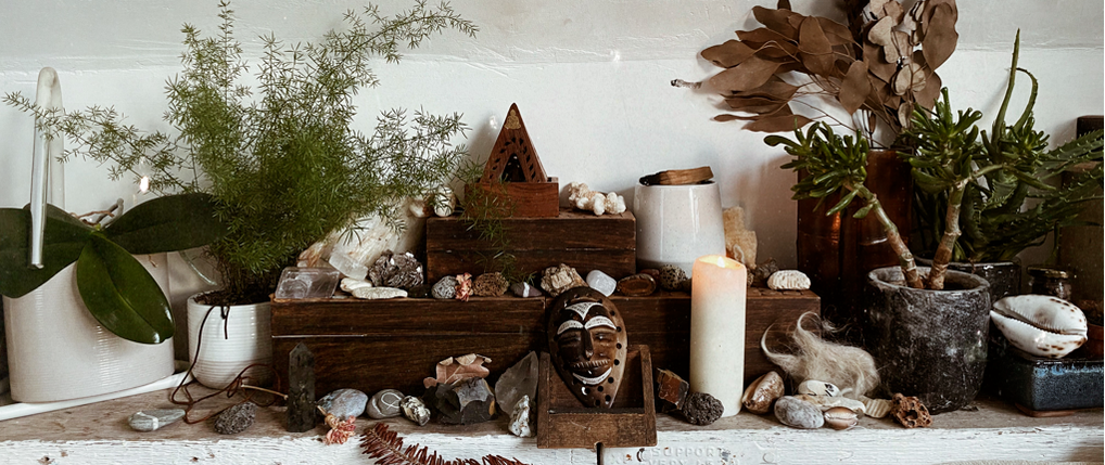 spiritual altar with candle, incense, crystals and plants