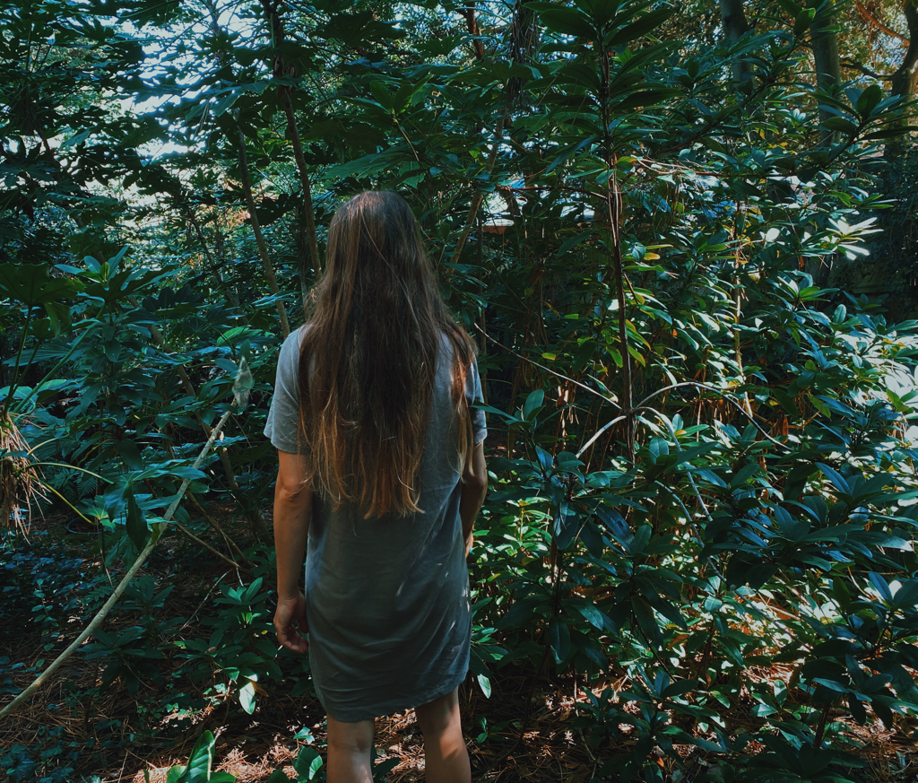The back of a girl in a forest